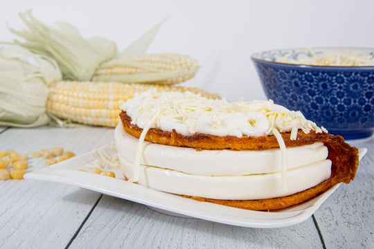 Cachapa Sweet Corn Venezuelan Pancake with filled with queso de mano and with shredded cheese on top