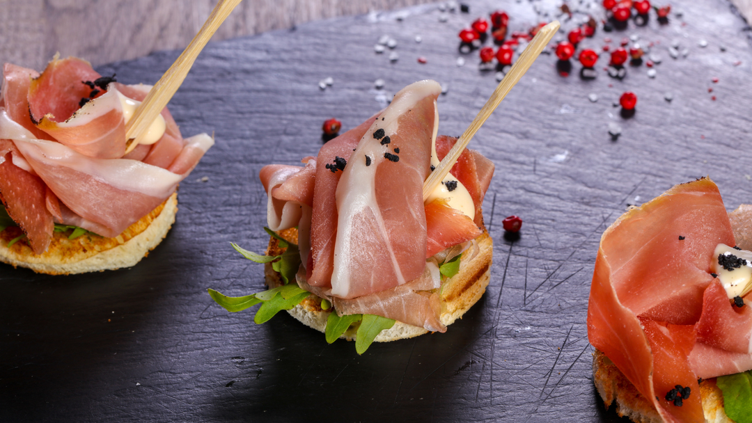 3 Iberico Han Bruschetas placed on a grey cutting board