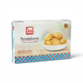 A box of PAISA Pandebono Artisan Cheese Bread, uncooked crudo, shown on a clean white background. The packaging features a white top half with a photo of golden-brown bread rolls in a white bowl, and a blue and red checkered pattern along the bottom.