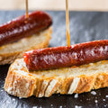 Montaditos de chistorra, chistorra soausage on top of Spanish bread