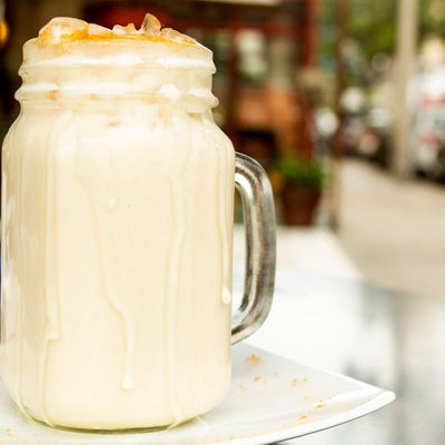 A refreshing Venezuelan chicha juice infused with rice, milk, and cinnamon, served in a glass